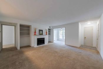 A spacious living room with a fireplace at Laurel Springs in Raleigh, NC,